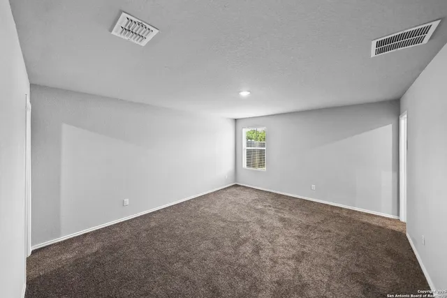 an empty room with a empty space and windows