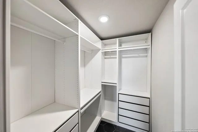 a bathroom with a granite countertop sink a toilet a mirror and shower