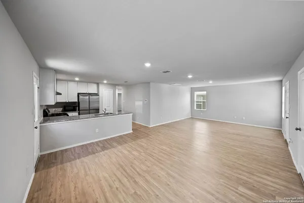 a view of a kitchen with a sink and a refrigerator
