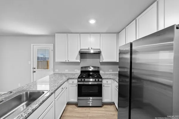 a kitchen with a refrigerator and a sink