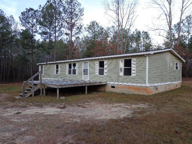 507 Harmony Road Buckhead, GA 30625 - Photo 1 of 1 a backyard of a house with wooden deck and barbeque oven