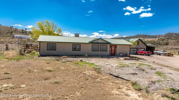 a view of a house with a snow in the yard