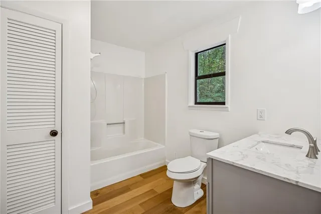 a utility room with wooden floor washer and dryer