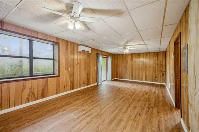 a kitchen with a refrigerator wooden floor and window