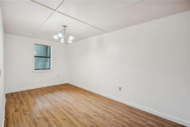 a view of a kitchen with stainless steel appliances wooden floor and a window