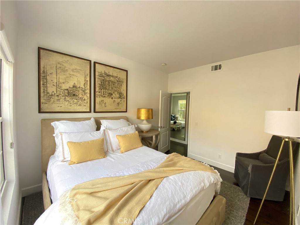 40 Anjou Newport Coast, CA 92657 - Photo 23 of 33 a bedroom with a bed and wooden floor