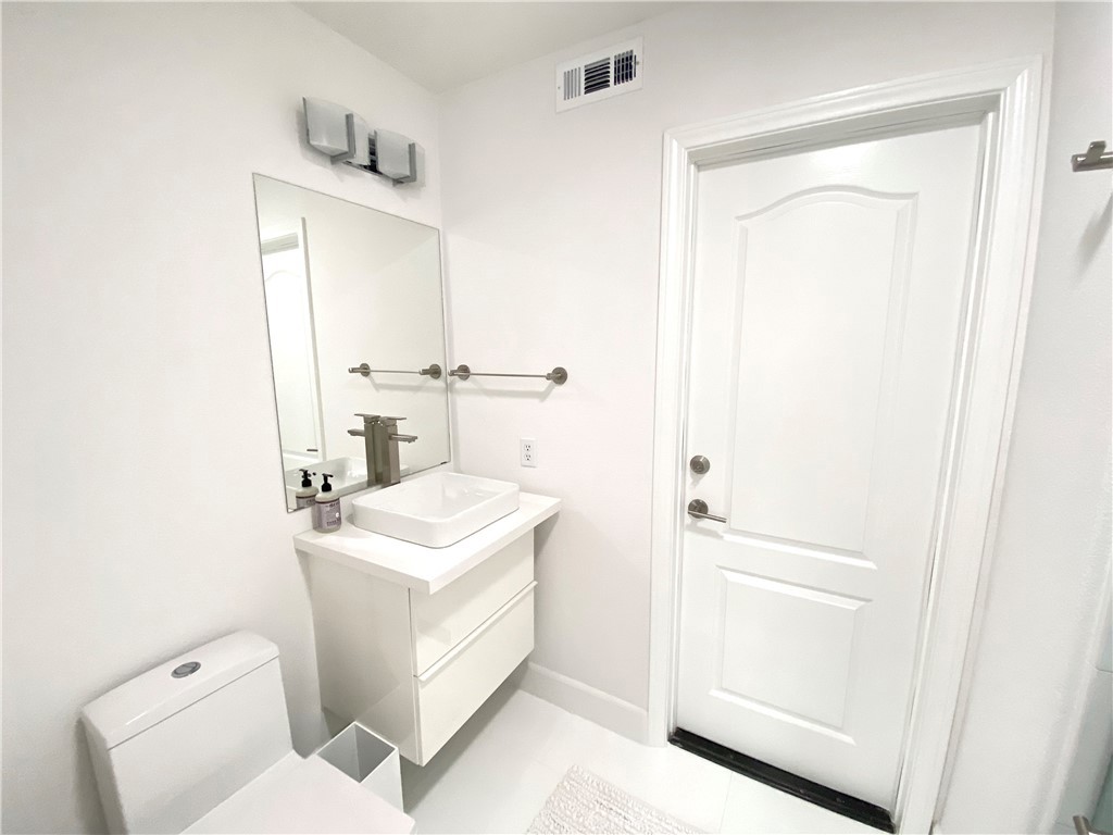 40 Anjou Newport Coast, CA 92657 - Photo 28 of 33 a bathroom with a sink a toilet and vanity