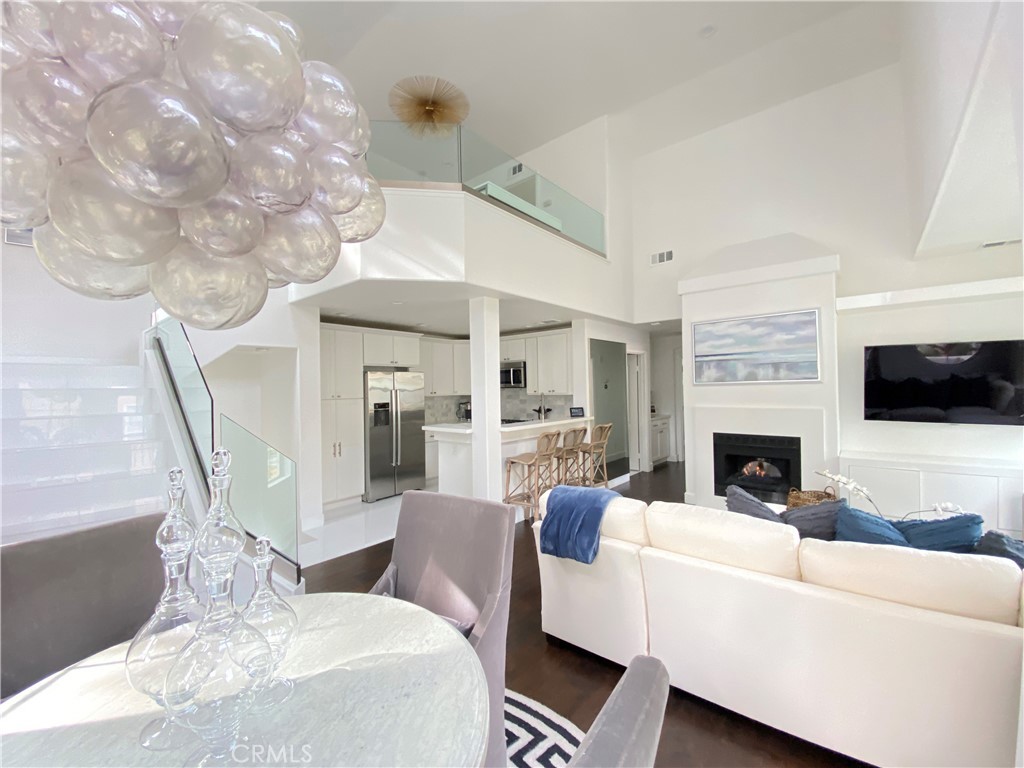 40 Anjou Newport Coast, CA 92657 - Photo 9 of 33 a living room with furniture a fireplace and a flat screen tv