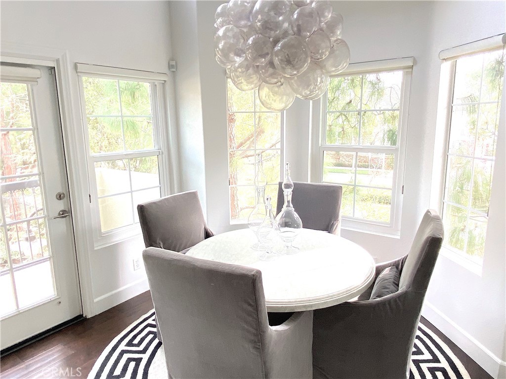 40 Anjou Newport Coast, CA 92657 - Photo 10 of 33 a dining room with furniture a chandelier and wooden floor