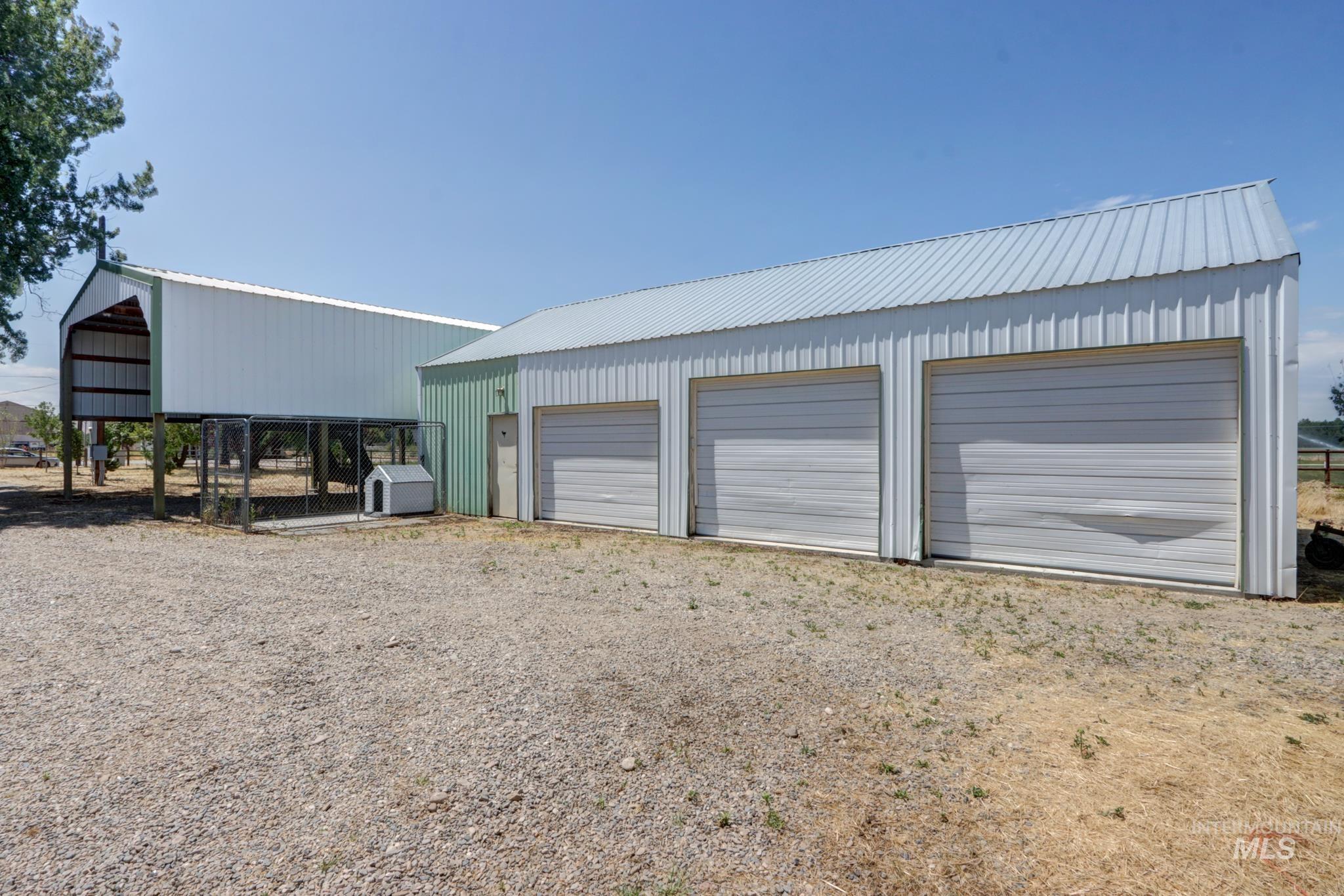 2528 Waterwheel Road Emmett, ID 83617 - Photo 2 of 50 White siding exterior with a green metal roof
