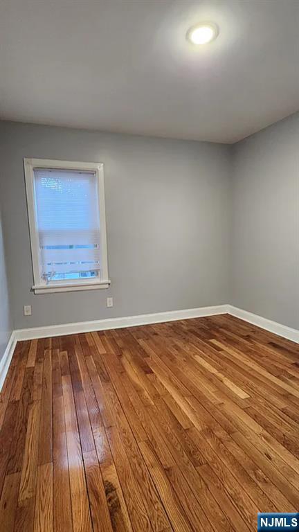 258 Franklin Street, Unit 1 Bloomfield, NJ 07003 - Photo 11 of 23 a view of a room with wooden floor and bench