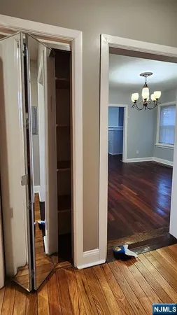 a view of a livingroom with wooden floor and stairs