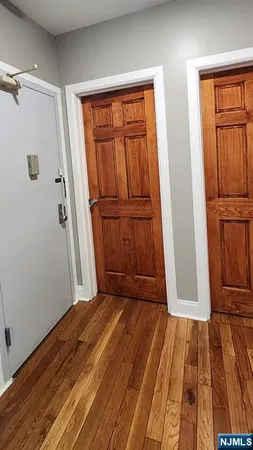 an empty room with wooden floor and sliding door
