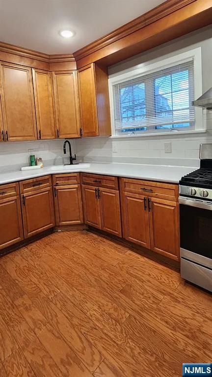 258 Franklin Street, Unit 1 Bloomfield, NJ 07003 - Photo 16 of 23 a kitchen with stainless steel appliances granite countertop a sink cabinets and wooden floor