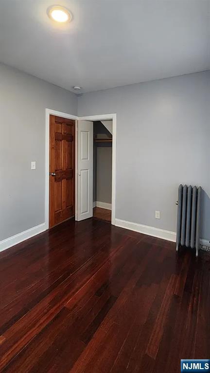 258 Franklin Street, Unit 1 Bloomfield, NJ 07003 - Photo 22 of 23 a view of an empty room with wooden floor and a window