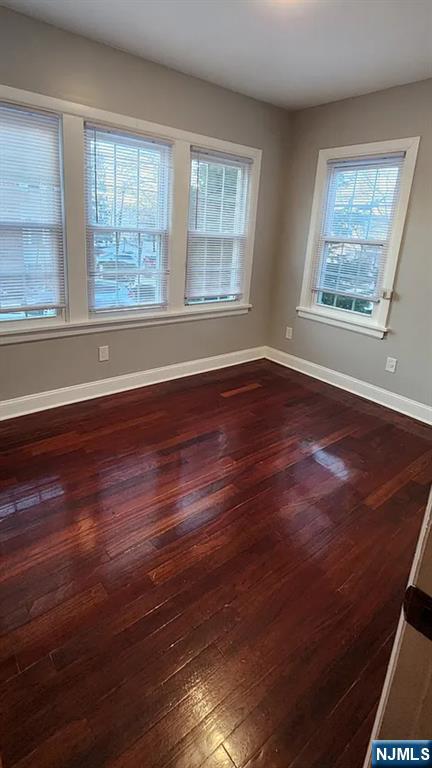 258 Franklin Street, Unit 1 Bloomfield, NJ 07003 - Photo 23 of 23 a view of an empty room with wooden floor and a window