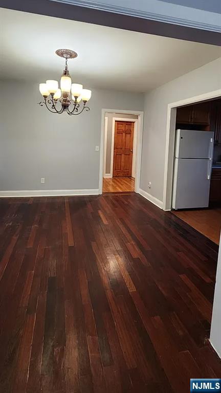 258 Franklin Street, Unit 1 Bloomfield, NJ 07003 - Photo 5 of 23 a view of an empty room with wooden floor and a window