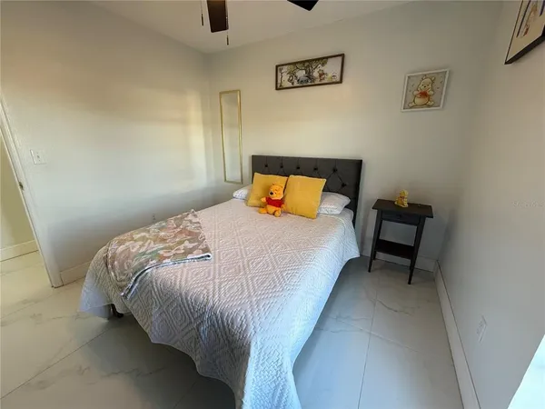 a bedroom with bed and a night stand