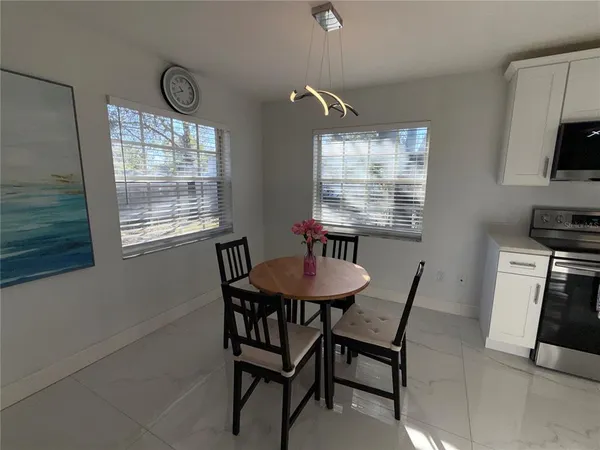 a dining room with furniture and window