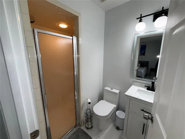 a white toilet sitting next to a bathroom sink