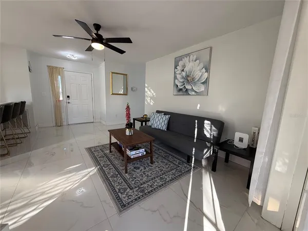 a living room with furniture and a rug