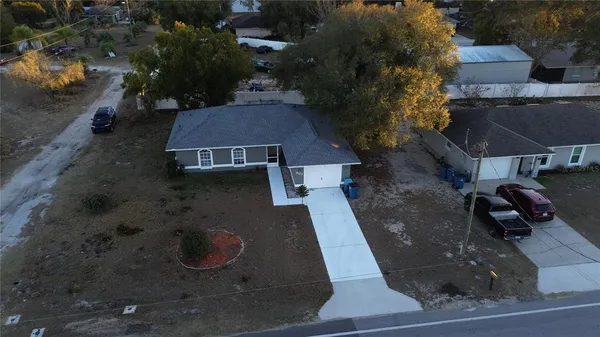 an aerial view of a house with a yard