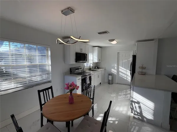 a very nice looking dining room with a large window