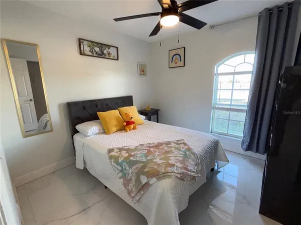 a bed sitting in a bedroom next to a window