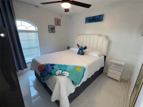 a bedroom with a bed and a chandelier