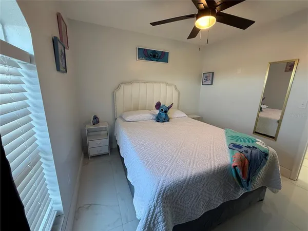 a bedroom with a bed and a chandelier