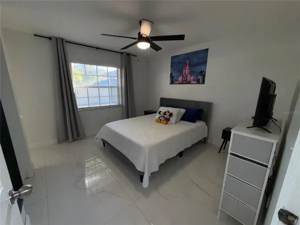 a bedroom with a bed and a window