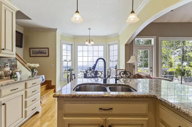 a kitchen with stainless steel appliances granite countertop a refrigerator and a stove