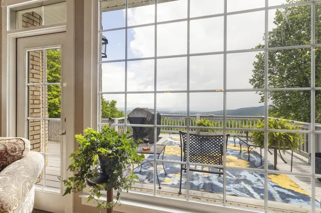 a bedroom with a bed next to a window