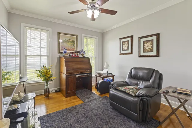 a bedroom with a bed a window and dresser