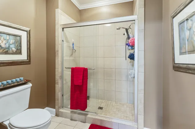 a white toilet sitting next to a shower
