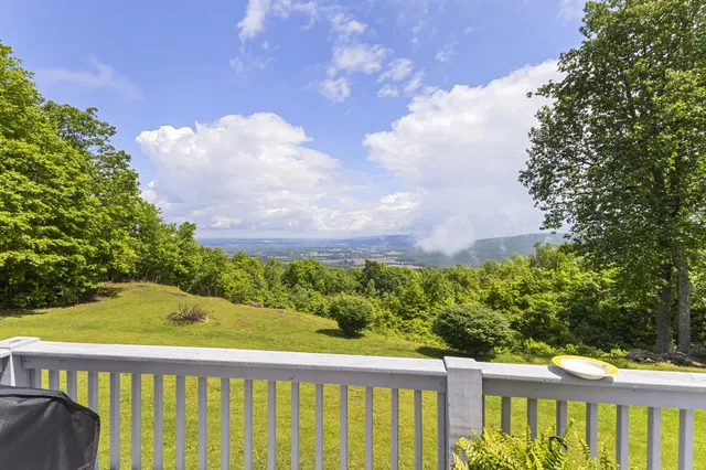 a view of a house with a backyard and sitting area