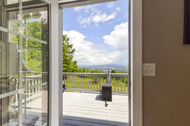 a view of a house with a backyard and a patio