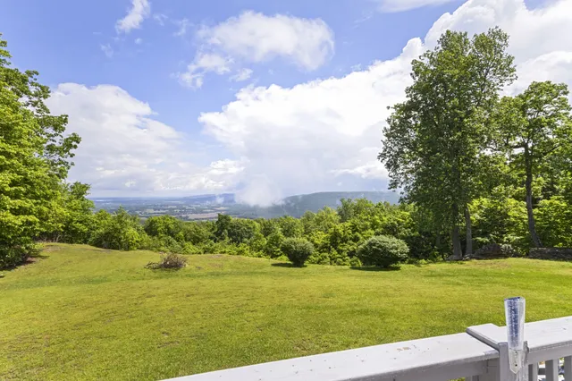 a front view of a house with a yard table and chairs