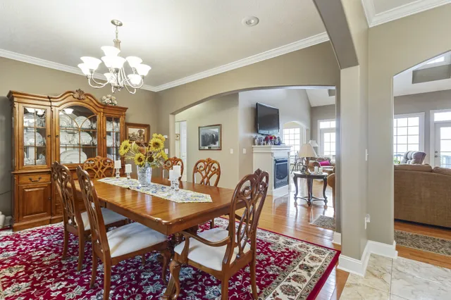 a view of a dining room with furniture and chandelier