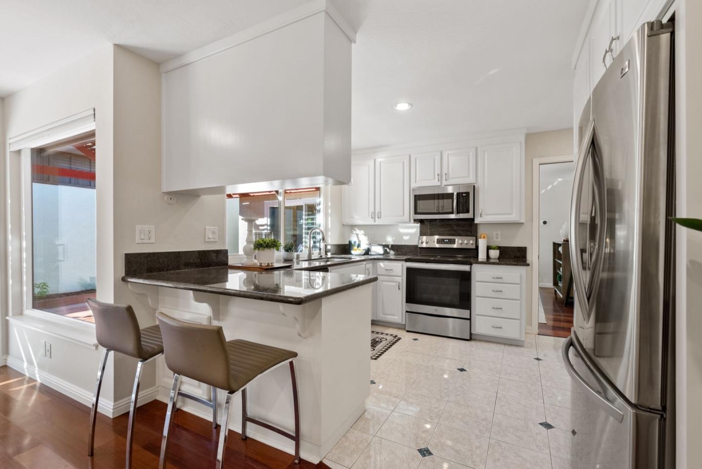 76 Jim Elder Drive Campbell, CA 95008 - Photo 11 of 37 a kitchen with stainless steel appliances a stove a sink and a refrigerator