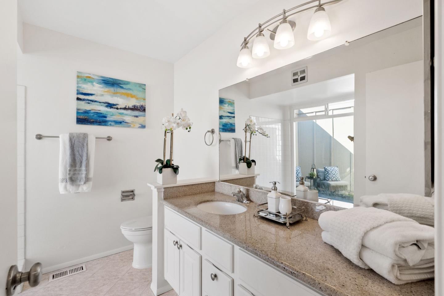 76 Jim Elder Drive Campbell, CA 95008 - Photo 17 of 37 a bathroom with double vanity sinks a toilet a mirror and shower