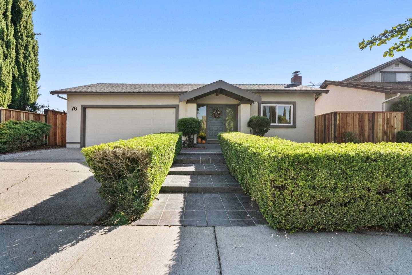76 Jim Elder Drive Campbell, CA 95008 - Photo 2 of 37 a front view of a house with a yard and garage