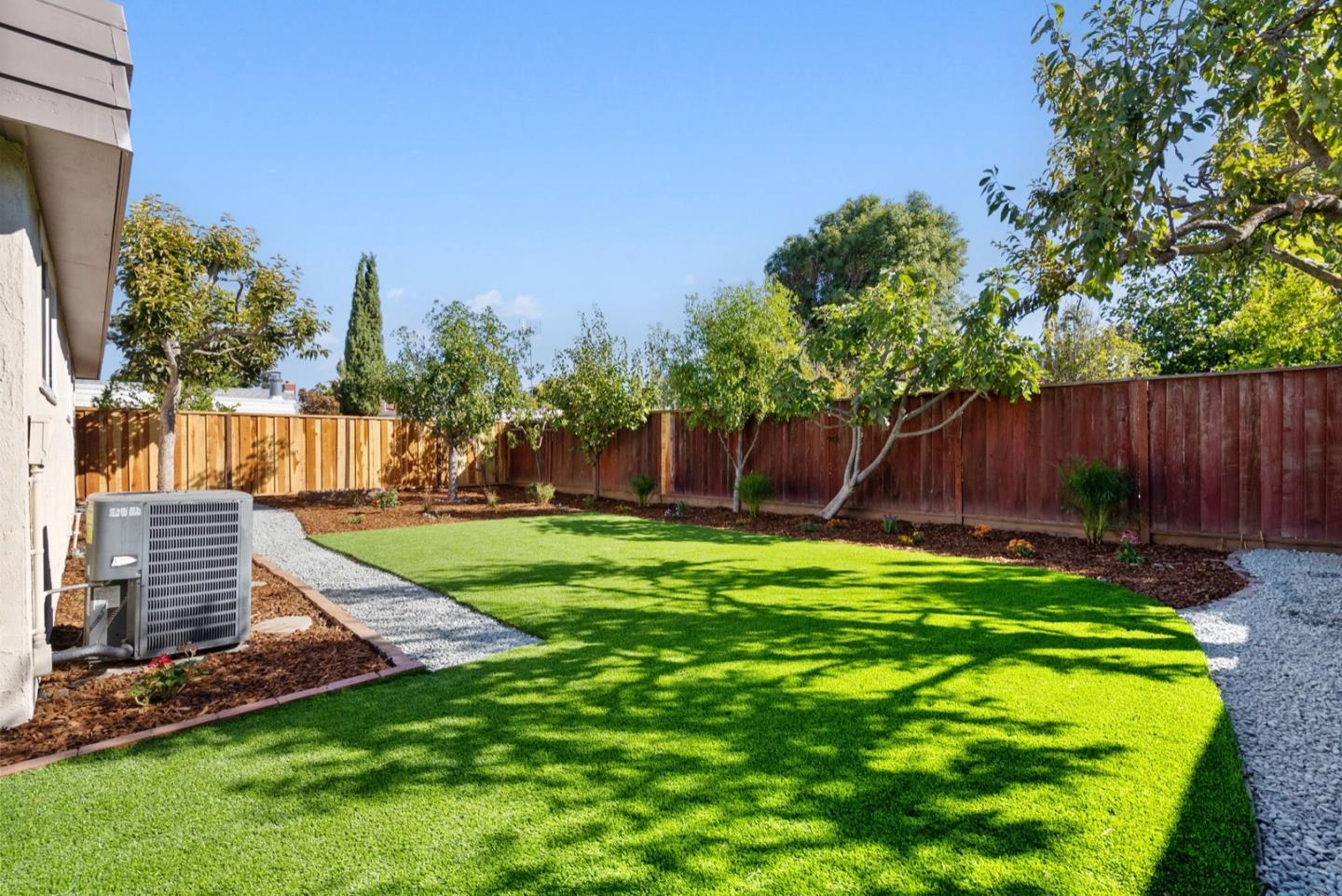 76 Jim Elder Drive Campbell, CA 95008 - Photo 29 of 37 a view of a backyard with table and chairs and wooden fence
