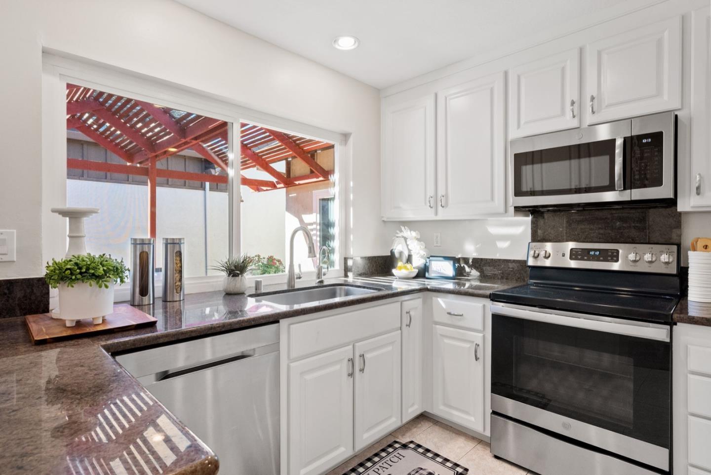 76 Jim Elder Drive Campbell, CA 95008 - Photo 10 of 37 a kitchen with stainless steel appliances a stove a sink and a microwave