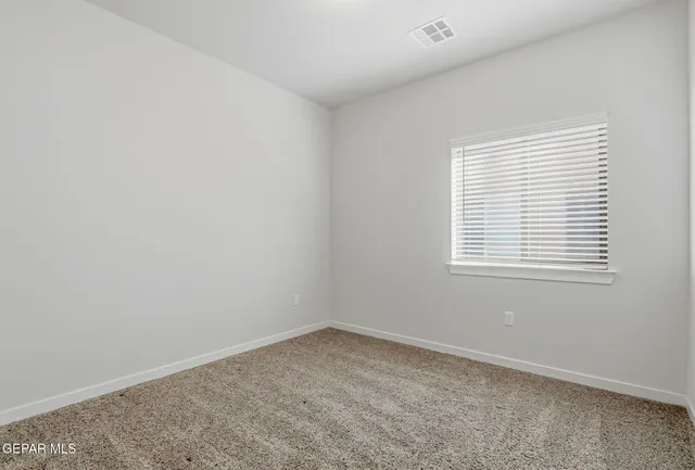 a bedroom with a bed a table and chair