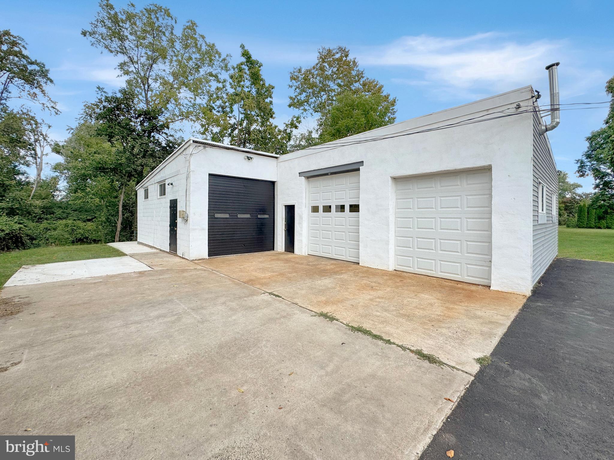 1027 Riverside Drive Pottstown, PA 19465 - Photo 18 of 24 a view of a white house with a yard and garage