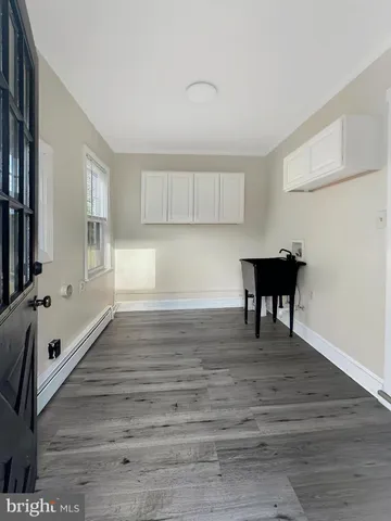 a view of a room with wooden floor and lounge chairs