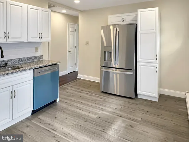 a kitchen with stainless steel appliances granite countertop a refrigerator stove and a sink