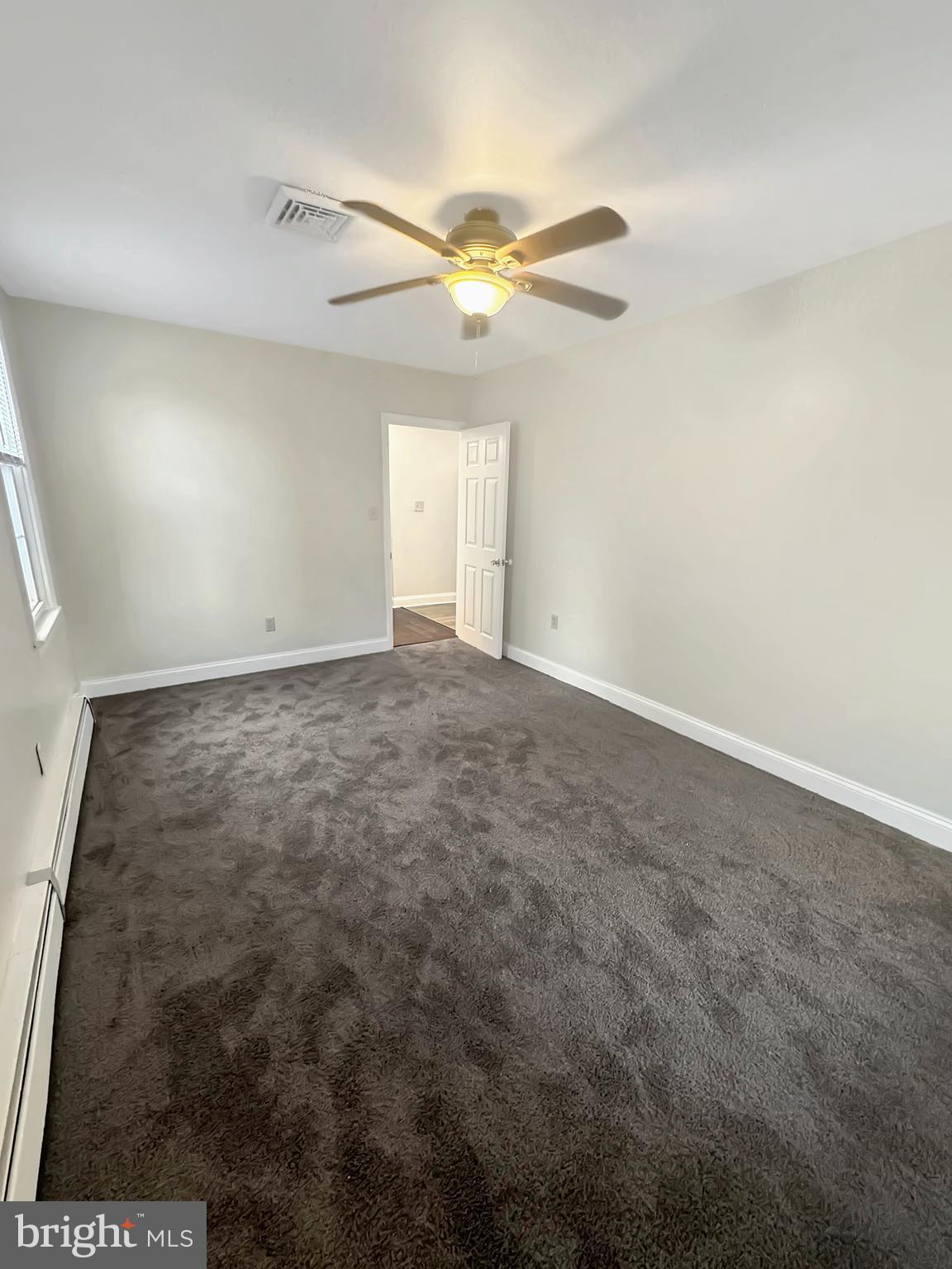 1027 Riverside Drive Pottstown, PA 19465 - Photo 8 of 24 en empty room with windows and ceiling fan