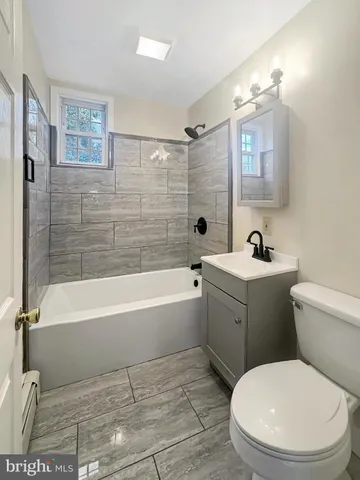a bathroom with a toilet a sink and bathtub